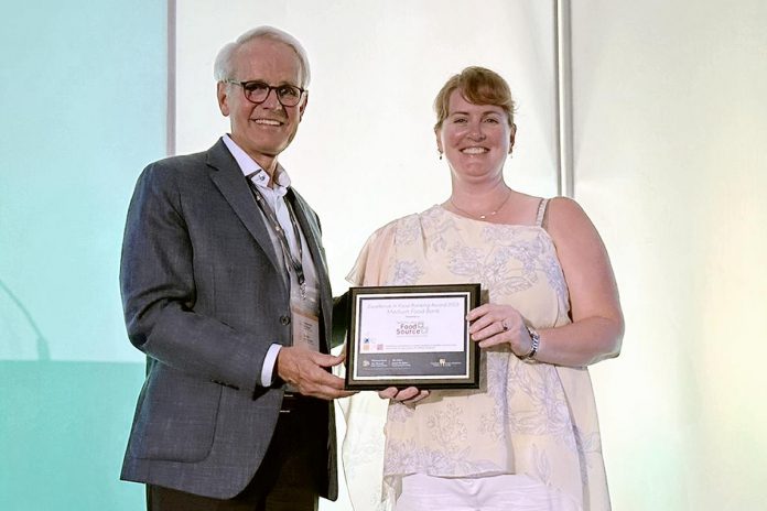 Peter Singer, vice chair of Food Banks Canada's board of directors, presented the Excellence in Food Banking Award to Kawartha Lakes Food Source executive director Heather Kirby at Food Banks Canada's 2023 National Conference in Edmonton, Alberta on June 27, 2023. (Photo courtesy of Food Banks Canada)