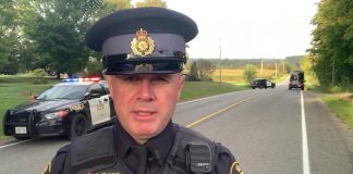 Constable James Clarke of the Northumberland OPP near the scene of a fatal single-vehicle collision on the afternoon of September 28, 2023. (kawarthaNOW screenshot of OPP video)