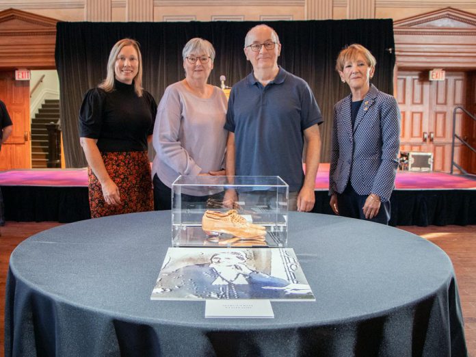 Eileen and Tom James (middle) travelled from British Columbia to donate a family heirloom to the Northumberland County Archives and Museum on September 26, 2023. The pair of shoes was worn by their ancestor Marguerite Pentland in 1860 during a gala dance with the Prince of Wales after he officially opened Cobourg's Victoria Hall. Also pictured at Victoria Hall in Cobourg are Northumberland County Archives and Museum curator Katie Kennedy (left) and Northumberland County warden Mandy Martin. (Photo courtesy of Northumberland County)