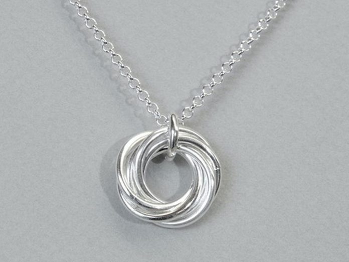 Douro-based jeweller and goldsmith Sandy MacFarlane's piece "Large Mobius Knot Pendant" (2023, sterling silver rings on 18" sterling silver rolo chain, 22 mm x 20 mm x 9.5 mm) is be one of the many artworks that will be auctioned off at the Art Gallery of Peterborough's It's All About ART fundraiser at The Venue in downtown Peterborough on October 28, 2023. (Photo courtesy of Art Gallery of Peterborough)
