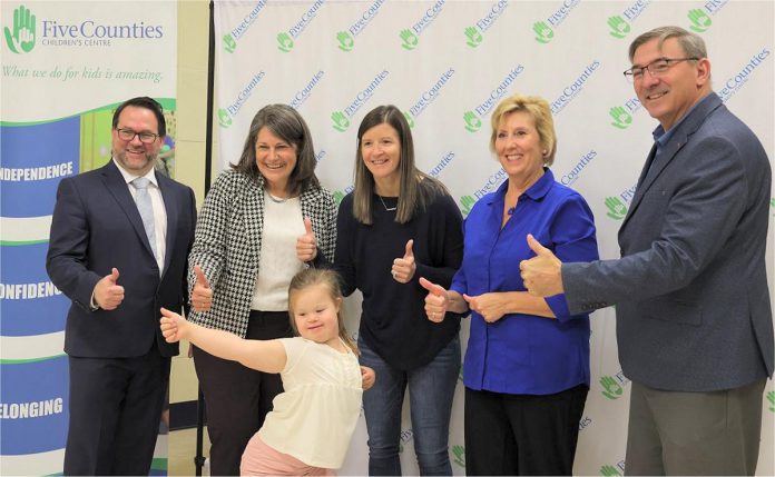 Seven-year-old Alexa and her mom Ashley Kulla (third from left) joined Five Counties CEO Scott Pepin and board of directors chair Julie Davis (left and second from left) and Haliburton-Kawartha Lakes-Brock MPP Laurie Scott and Peterborough-Kawartha MPP Dave Smith for a thumbs-up after the Ontario government announced an increase of $2 million in funding for the charitable organization on October 12, 2023. (Photo courtesy of Five Counties Children Centre).
