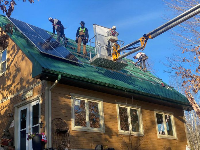 Workers from Peterborough-based business Generation Solar install solar panels at Lake Edge Cottages in Lakefield. (Photo: Generation Solar)
