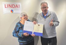 Peterborough Mayor Jeff Leal presented longtime volunteer Linda Shisko with a letter and certificate from the City of Peterborough recognizing her 30 years of volunteer service to the community at the Market Hall in Peterborough on October 20, 2023. Linda, who has provided weekly cleaning services for at least a dozen non-profit agencies since 1996, is retiring in advance of her 73rd birthday. (Photo: Eva Fisher / Public Energy Performing Arts)