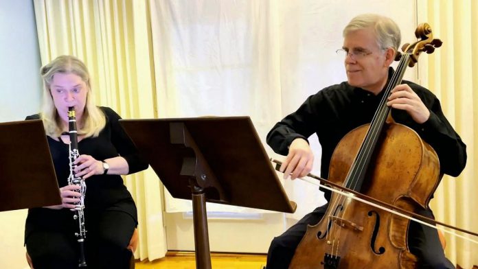 Cellist, conductor, composer, teacher, and recording producer Ronald Royer performing with his wife Kaye in 2021. Ronald is the music director and conductor of the Scarborough Philharmonic Orchestra, and Kaye is the orchestra's principal clarinetist. (kawarthaNOW screenshot of Scarborough Philharmonic Orchestra video)