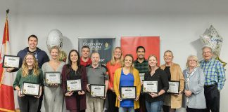 The nine Peterborough-area entrepreneurs who participated in the 2023 ScaleUP program (holding plaques) along with Scotiabank's Ontario Central East district vice president Chris Skinner and Community Futures Peterborough executive director Devon Girard (middle back row) and Peterborough County Warden Bonnie Clark and Peterborough Mayor Jeff Leal (right) during a graduation celebration at VentureNorth in downtown Peterborough on October 26, 2023. (Photo: Heather Doughty for Community Futures Peterborough)