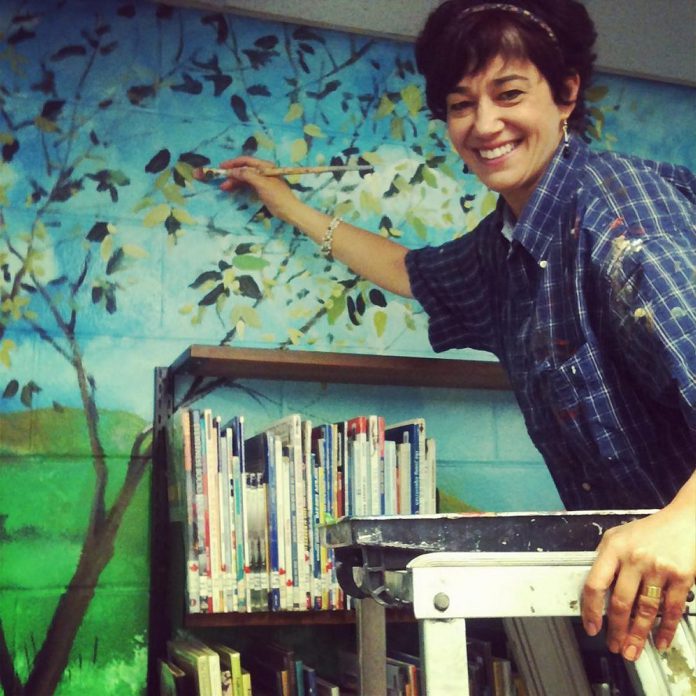 A graduate in fine arts from York University, Silvia Ferreri never lost her passion for art even when she was running her successful retail business Pensieri Shoes in downtown Peterborough. She regularly volunteered to paint murals at local schools, including this one in the library at St. Paul Catholic Elementary School in Peterborough in 2012. (Photo: Carol Lawless)