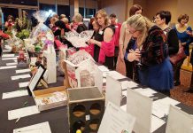 Members of the Women's Business Network of Peterborough (WBN) browse silent auction items at the organization's 2016 Holiday Gala and Auction Fundraiser. For the third year in a row, the networking organization is also hosting an online auction to help meet its goal of raising $15,000 in support of the YWCA Peterborough Haliburton's programs and services for local women and children fleeing abuse and violence. (Photo: WBN)