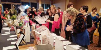 Members of the Women's Business Network of Peterborough (WBN) browse silent auction items at the organization's 2016 Holiday Gala and Auction Fundraiser. For the third year in a row, the networking organization is also hosting an online auction to help meet its goal of raising $15,000 in support of the YWCA Peterborough Haliburton's programs and services for local women and children fleeing abuse and violence. (Photo: WBN)