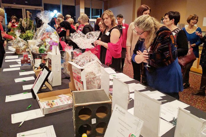Members of the Women's Business Network of Peterborough (WBN) browse silent auction items at the organization's 2016 Holiday Gala and Auction Fundraiser. For the third year in a row, the networking organization is also hosting an online auction to help meet its goal of raising $15,000 in support of the YWCA Peterborough Haliburton's programs and services for local women and children fleeing abuse and violence. (Photo: WBN)