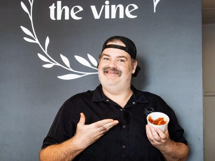 The Vine co-owner Tyrone Flowers with a sample of his restaurant's festival-winning kimchi-infused mac and cheese dish. (Photo courtesy of Peterborough DBIA)