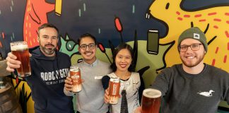 Reggie Maranda of Mcthirsty's Pint (left) and Garrett Bulmer of Bobcaygeon Brewing Company (right), pictured with Mauricio Interiano and Paris Nguyen of the New Canadians Centre, raise a pint of West Coast Pale Ale, the third beer in the 'Community Brew' series, with a portion of sales to be donated to New Canadians Centre. (Photo: Luke Best / Bobcaygeon Brewing Company)