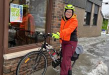 Eileen Kimmett, coordinator of the GreenUP Store & Resource Centre, stands in full winter cycling gear with her bike after a five-kilometre commute in 2022 from her home to the GreenUP Store in downtown Peterborough. (Photo: GreenUP)