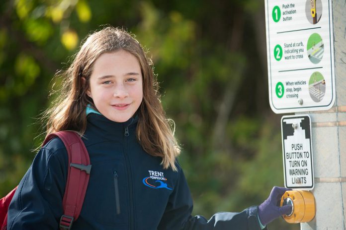 One of the main reasons parents drive their kids to school is because they are concerned about their safety. Organizing a "walking school bus" where parents or volunteers lead a group of children to school adds visibility and increases safety while also serving as a reminder that our streets and cities are for people, not just people in cars.  (Photo: Active School Travel Peterborough)