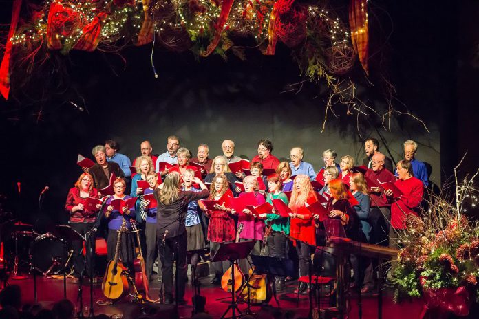 In From The Cold co-founder Susan Newman leading the Convivio Chorus during the benefit concert for Peterborough's YES Shelter for Youth and Families in 2015, including co-founders Rob Fortin (second row, far left), Curtis Driedger (back, far right), and John Hoffman (third row, second from right). In From The Cold returns for its 24th year on December 3 and 9, 2023 at Market Hall Performing Arts Centre. (Photo: Linda McIlwain / kawarthaNOW)