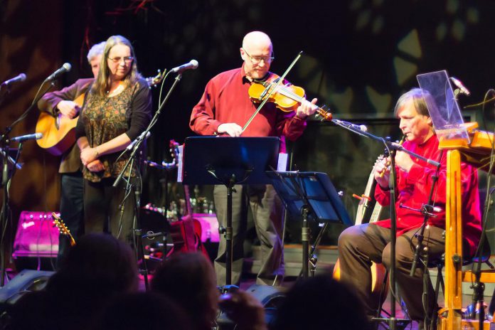 Carried Away (Rob Fortin, Susan Newman, and John Hoffman) performing with Michael Ketemer during the In From The Cold benefit concert for Peterborough's YES Shelter for Youth and Families in 2015. As well as playing concertina, hammered dulcimer, recorder, and tin whistle, Ketemer performs a fingerstyle guitar solo during the concert. In From The Cold returns for its 24th year on December 8 and 9, 2023 at Market Hall Performing Arts Centre. (Photo: Linda McIlwain / kawarthaNOW)