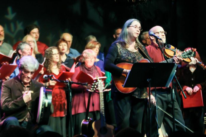 In From The Cold co-founders Rob Fortin, Susan Newman, and John Hoffman performing with the Convivio Chorus during the benefit concert for Peterborough's YES Shelter for Youth and Families in 2015. One of Peterborough’s most cherished Christmas concerts, it offers an enchanting mix of Celtic, traditional, contemporary and original Christmas and seasonal music you won’t hear at other concerts, performed by some of Peterborough’s top folk and roots musicians. In From The Cold returns for its 24th year on December 8 and 9, 2023 at Market Hall Performing Arts Centre. (Photo: Linda McIlwain / kawarthaNOW)