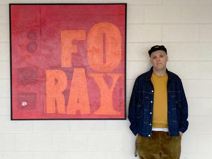 Artist Jeffrey Macklin was one of four local artists chosen for phase one of the City of Peterborough's public art project Indoor-Outdoor, which integrates artwork into city facilities and buildings. His "Foray" (2022, mixed media on plywood, 48x48in) is now one of the first things visitors see when stepping into the Kinsman Civic Centre. A relief (letterpress) printer, mixed media artist, and freelance graphic designer who owns and operates Jackson Creek Press, Macklin is also an advocate for the arts often hosts workshops and classes out of Peterborough's many supportive spaces, and organizes events for local artists like Focus Fair. (Photo: City of Peterborough)