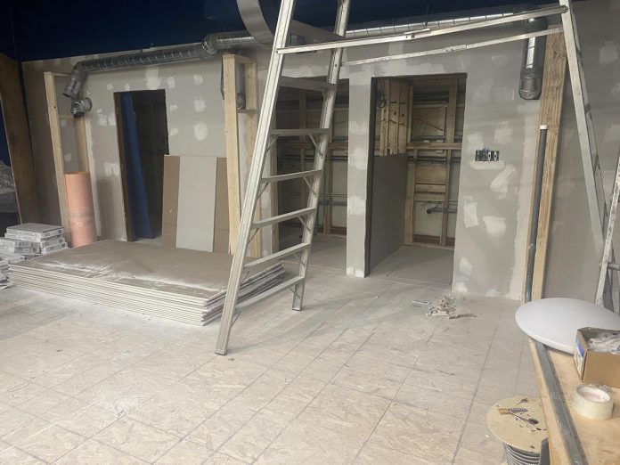 Washrooms and showers for the new Trinity Centre community hub for those experiencing homelessness are being installed in the stage area of the auditorium at the former Trinity United Church on Reid Street in Peterborough. (Photo: Paul Rellinger / kawarthaNOW)