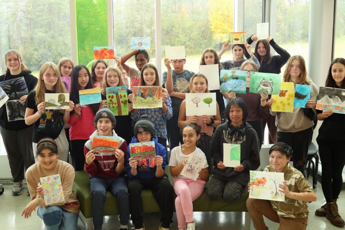 Grade 7 and 8 students from Kaawaatte East City Public School in Peterborough display the artworks they created this past fall during an outdoor art education experience at Ashburnham Memorial Park in fall 2023 led by volunteers with the Ashburnham Memorial Stewardship Group and local artist Laurel Paluck. The students' artworks are on display in the lower level of Peterborough Museum & Archives until December 30. (Photo courtesy of the Ashburnham Memorial Stewardship Group)