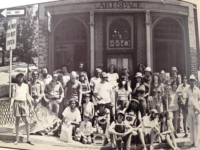 A photo outside Artspace in 1976, showing co-founder David Bierk (front row), Joe Stable (front right, wearing suspenders). Others pictured in the photo include Tobey Anderson, Eric Loder, Dorothy Caldwell, and David's first wife Kathleen Hunter-Bierk. (Photo courtesy of Alex Bierk)