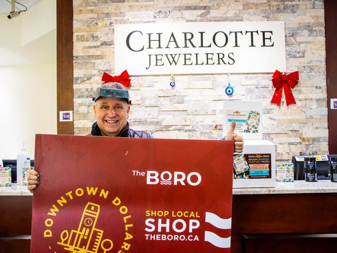 Charlotte Jewelers owner Levon Eginliyan gives the thumbs up after customer Margaret C. (not pictured) won a $500 Boro gift card after her Holiday Shopping Passport was drawn as the second early bird winner. (Photo courtesy of Peterborough DBIA)