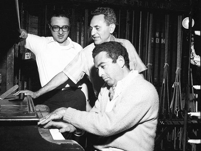 Sheldon Harnick, Joseph Stein, and Jerry Bock (at the piano) working on the lyrics, book, and music for the original production of "Fiddler on the Roof," which opened on Broadway in September 1964. Stein and Bock both passed away in 2010 and Harnick passed away in June 2023 at the age of 99. (Photo: Eileen Darby)