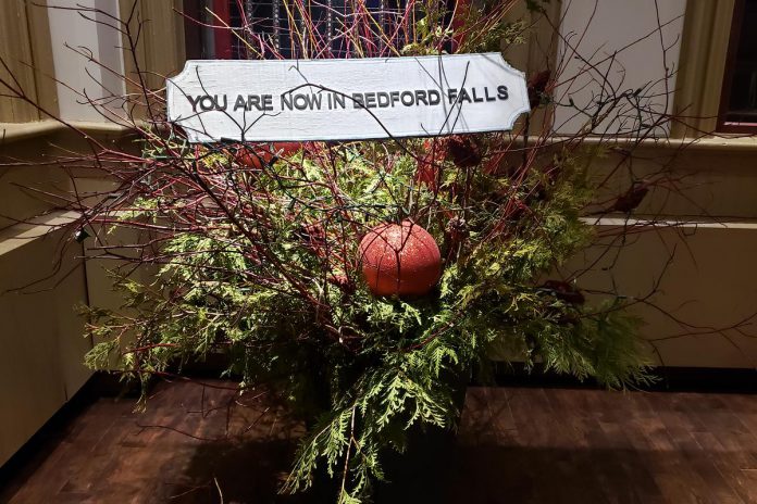 A sign outside the lobby of Market Hall Performing Arts Centre welcomes members of the live "studio" audience to New Stages Peterborough's production of "It's a Wonderful Life: A Live Radio Play" until December 17, 2023. (Photo: Jeannine Taylor / kawarthaNOW)