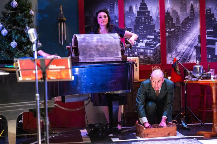 Actors Megan Murphy and Kerry Griffin creating some sound effects during New Stages Peterborough's production of "It's a Wonderful Life: A Live Radio Play" at Market Hall Performing Arts Centre. (Photo: Dahlia Katz)