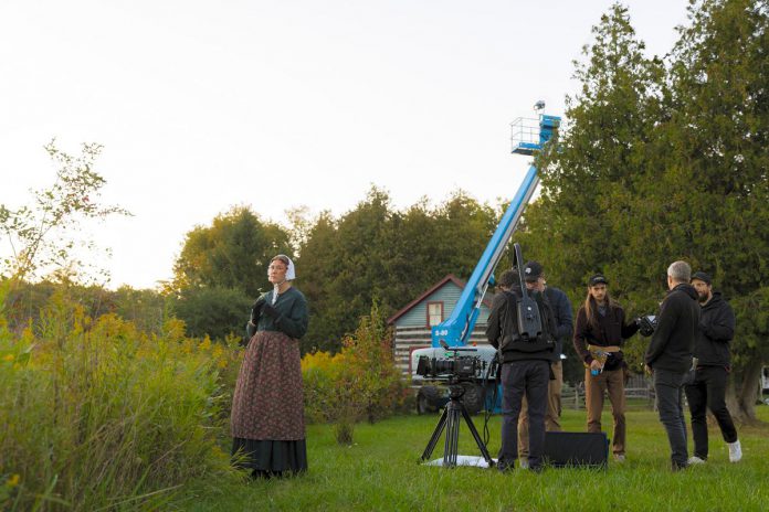 Peterborough actor Naomi Duvall waits as the production crew including Pawel Dwulit, Christian Moes, Drew Antzis, and Rob Viscardis prepares for a scene during the Paradigm Pictures filming of a proof-of-concept mini-series called "Grist" at Lang Pioneer Village in Keene in September 2023. Dwulit is involved in the Peterborough Kawartha Film Office, a not-for-profit organization currently curating a list of shooting locations as part of a three-phase plan to establish the region as a film production destination. (Photo: Zach Ward)