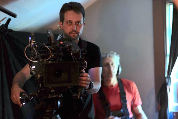 Director of photography and co-director Pawel Dwulit waits for actors to reset a scene as co-director Drew Antis looks on during the production of a proof-of-concept mini-series called "Grist" at Lang Pioneer Village in Keene in October 2023. Dwulit is the owner of Peterborough-based production company Paradigm Pictures, which specializes in commercials, music videos, documentaries, and narrative film. (Photo: Adam Martignetti)