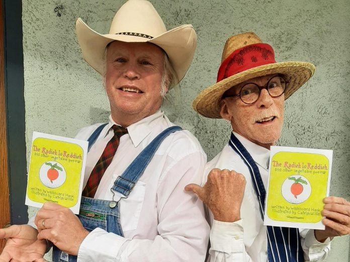 Hank "Washboard Hank" Fisher and Willie "Catfish Willie" Lindsay with the children's book of poetry entitled "The Radish is Reddish and Other Vegetable Poems." (Photo courtesy of Washboard Hank and Catfish Willie)