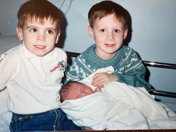 A young Eric Roter (left) with his brother Sam Roter with their newborn sister Haley. (Photo courtesy of the Roter family)