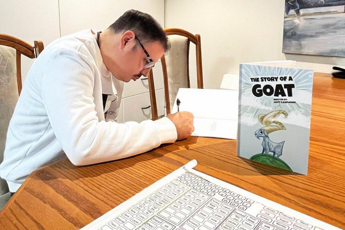 Peterborough author Scott Kalbfleisch signing copies of his children's book "The Story of A Goat" for workers at Shared Dreams for Independent Living, a joint living space at  at The Mount Community Centre for men with physical and developmental challenges.  Kalbfleisch will be signing copies of his book during a book launch hosted at the GreenUP Store in downtown Peterborough from 10 a.m. to 3 p.m. on January 10, 2024.  (Photo: Shared Dreams for Independent Living / Facebook)