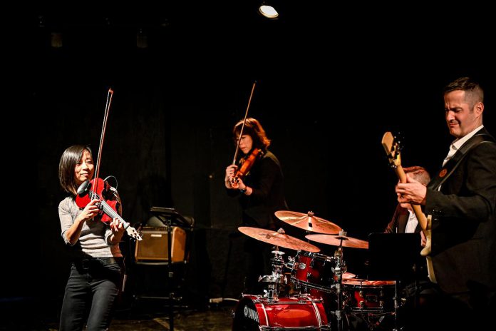 Violinist Victoria Yeh (left) performing with her Spirit Awakens band during her "Timeless" concert at The Theatre On King on December 21, 2022. As the final concert of her "Travel by Sound" six-concert music series, Yeh will be performing a new "Timeless" concert at Peterborough's Market Hall on the winter solstice on December 21, 2023. (Photo: Trevor Hesselink / Groundswell Photography)