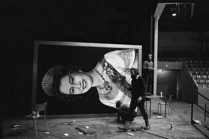 Peterborough artist David Bierk walks in front of his portrait of Queen Elizabeth II as it is prepared for installation at the Peterborough Memorial Centre on January 9, 1980. (Photo courtesy of Sebastian Bach)