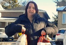 Lion Makaya Dafoe with two of the 75 turkeys and hams donated by individuals, businesses, and service clubs to the East Peterborough Lions Club for delivery to families in need during the annual Great Turkey Exchange. (Photo: East Peterborough Lions Club / Facebook)
