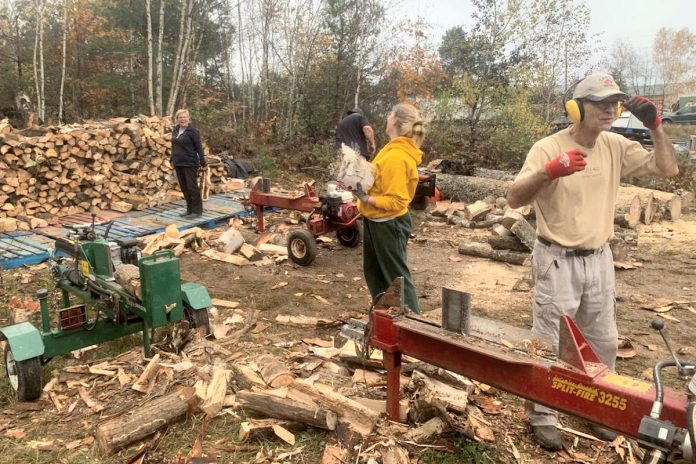 Volunteers splitting and stacking firewood as part of Heat Bank Haliburton County, a program of the Central Food Network. (Photo: Central Food Network)
