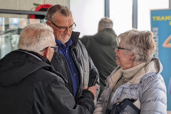 Writer Paul Rellinger speaks with Robert and Jill Staples of Staples Maple Syrup, two of the 14 inductees of JA-NEO's 2024 Business Hall of Fame announced at VentureNorth in downtown Peterborough on January 17, 2024. (Photo: Bruce Head / kawarthaNOW)