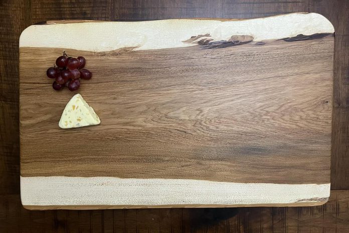 One of Millbrook resident David McNab's handmade butternut charcuterie boards (28" x 17", 2" thick). Butternut is endangered and can be harvested only when a tree dies. This board (which costs $180, with optional handles for $15 and up) is available as part of McNab's raffle fundraiser for education costs for a 10-year-old Kenyan boy. McNab will also donate 100 per cent of proceeds from sales of his boards during the fundraiser. (Photo: David McNab)