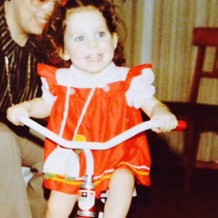 A very young Megan Murphy riding a tricycle. She grew up "obsessed" with Anne of Green Gables, imagining her life to be just as literary and dramatic. As a child, she would stage productions with her friends and sisters for an audience of parents, while using performance to make chores a lot more fun. (Photo courtesy of Megan Murphy)