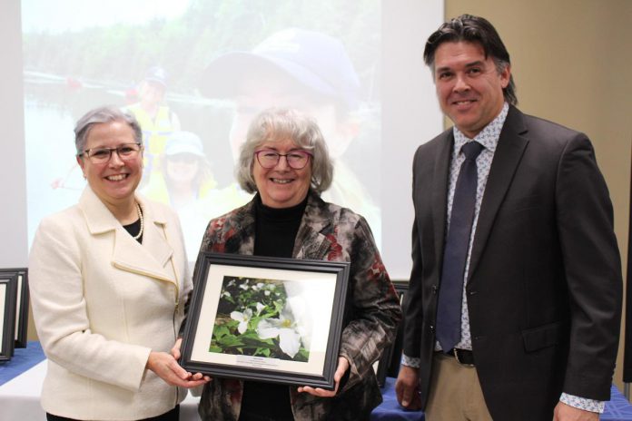 Cathy Dueck (middle) accepts the 2024 Individual Conservationist Award from Otonabee Conservation CAO Janette Loveys Smith and the organization's new board chair Michael Metcalf at Otonabee Conservation's annual general meeting on January 18, 2024 at the Riverview Park and Zoo Rotary Education Centre. A lifelong naturalist, Dueck has contributed to the naturalization of many parks and greenspaces, including founding what would become Peterborough GreenUP's Ecology Park. Most recently, as the coordinator of the Pathway to Stewardship Project, Dueck worked to develop resources and opportunities to help families, students, and community members get outside and enjoy nature. (Photo courtesy of Otonabee Conservation)