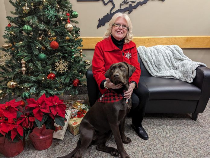 Peterborough County warden Bonnie Clark with Peterborough County-City Paramedics service dog Charlie in December 2023. In 2024, the county is working with the City of Peterborough on negotiating the consolidated municipal service agreement between the two local governments, including the county overseeing the paramedic service for the county and city. (Photo: Peterborough County)