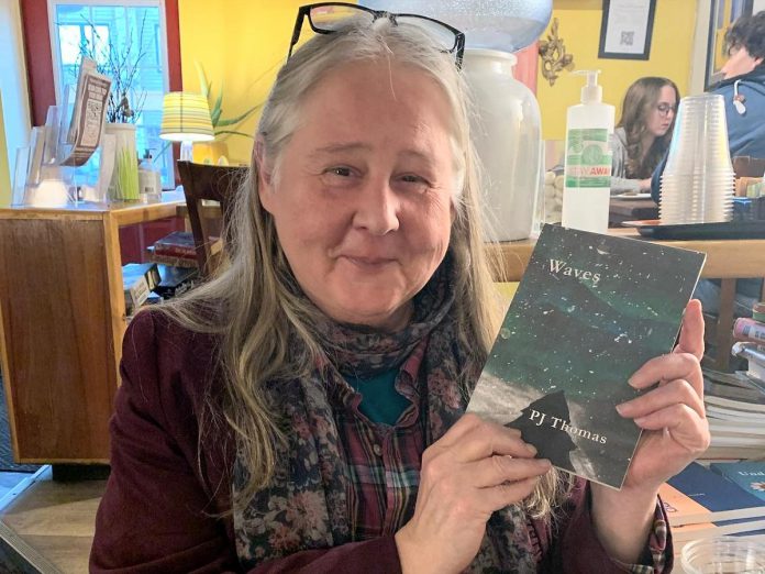 Peterborough poet PJ Thomas with her first book of poetry in 2022. Part of the Water Trilogy, "Waves" was followed by "Undertow" and the 12 Weeks of Bliss video series will include works to be published in "Drifting", the forthcoming third book in the series. (Photo: Adelle Purdham)