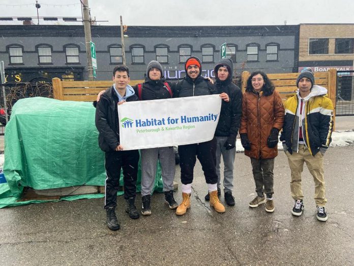 The 13th annual Tau Kappa Epsilon (TKE) student fraternity's "TKE in a Box" fundraiser returns to Peterborough from February 2 through 4, 2024. The 48-hour camp out aims to raise awareness about housing insecurity in the Peterborough region as well as funds for phase two of Habitat for Humanity Peterborough & Kawartha Region's Leahy's Lane affordable condo development. Pictured are TKE members during the 2023 fundraiser in the parking lot of VentureNorth in downtown Peterborough. (Photo: Tau Kappa Epsilon)