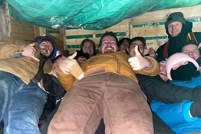 Members of the Tau Kappa Epsilon (TKE) student fraternity in Peterborough camping out "in a box" in the parking lot of VentureNorth in downtown Peterborough in 2023 to raise funds for Habitat for Humanity Peterborough & Kawartha Region and awareness about housing insecurity. The "TKE in a Box" fundraiser returns to Peterborough from February 2 through 4, 2024. (Photo: Tau Kappa Epsilon)