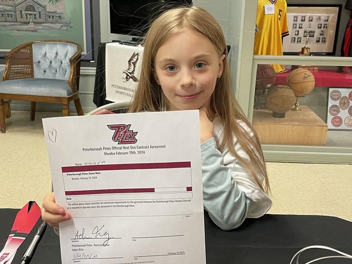 As part of the Next Gen Game experience on February 19, 2024, Five Counties kids like Autumn got to sign a one-day contract with the Peterborough Petes. (Photo courtesy of Five Counties Children's Centre)