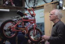 Volunteer John White works on a children's bike at B!KE - The Peterborough Community Bike Shop. The non-profit charitable organization is holding its annual Kids' Bike Build on April 14, 2024 and is seeking donations of used children's bikes that can be refurbished and given away to local organizations working with children and families. (Photo courtesy of B!KE)