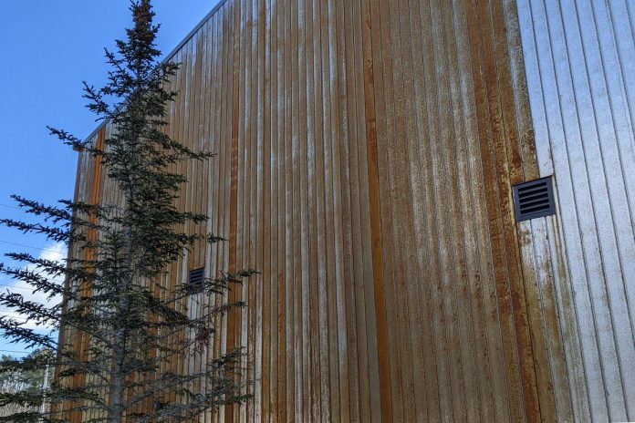 The new Canadian Canoe Museum under construction at 2077 Ashburnham Drive in Peterborough is clad in Corten steel siding. Also known as weathering steel, the siding is designed to rust with exposure to weather and will eventually form a stable surface with a rust-like patina finish. This finish guards against future corrosion and prevents the need to paint the steel in the future. (Photo: Bruce Head / kawarthaNOW)