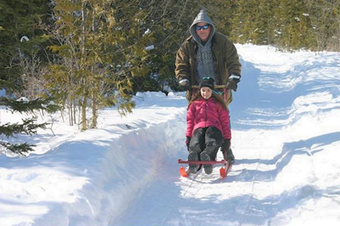 The annual Winterlude event at Gamiing Nature Centre in Kawartha Lakes take place on Family Day (February 19, 2024) and features a range of family-friendly activities including  kick-sledding. (Photo: Gamiing Nature Centre)