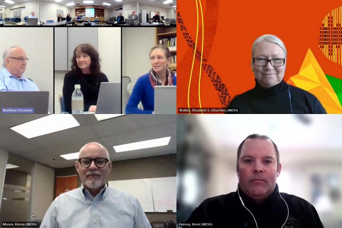 Ontario chief medical officer of health Dr. Kieran Moore (bottom left) attended the February 15, 2024 virtual meeting of the board of health for the Haliburton Kawartha Pine Ridge (HKPR) District Health Unit, along with two of his staff: public health division executive lead Elizabeth Walker (top right) and accountability and liaison branch director Brent Feeney (bottom right) to answer questions from board members about a possible merger with Peterborough Health Unit. (kawarthaNOW screenshot of YouTube video)